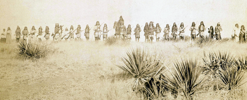 Line of Apache warriors and families with Geronimo, March 1886