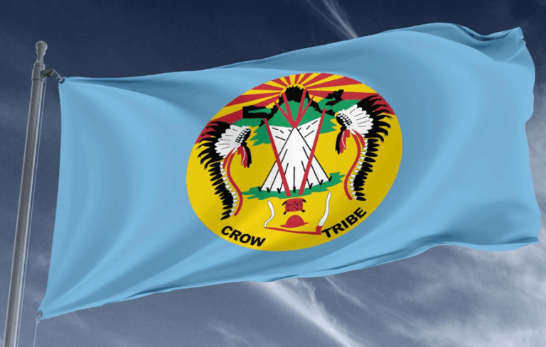 The Crow Nation tribal flag flying in a breeze