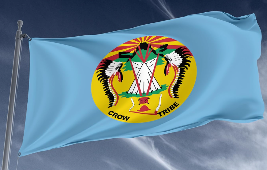 The Crow Nation tribal flag flying in a breeze