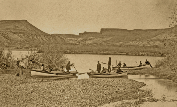 John Wesley Powell 1869 expedition crew in wooden boats along the Colorado River