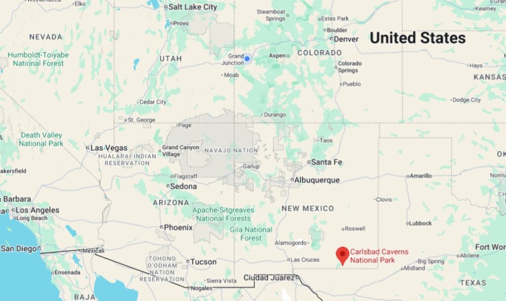 A regional map of the southwestern United States showing a red location pin for Carlsbad Caverns National Park in New Mexico.