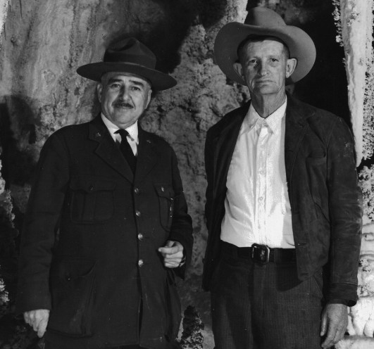 A vintage black-and-white photograph of Colonel Tom Boles and cowboy Jim White standing side-by-side.