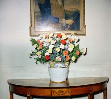 Colorful arrangement of fresh carnations displayed on an entryway table at the White House.