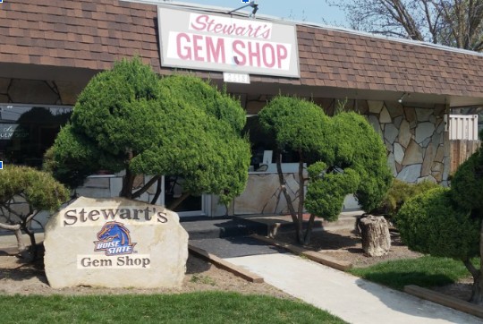 Exterior view of Stewart's Gem Shop storefront and stone sign in Boise, Idaho.
