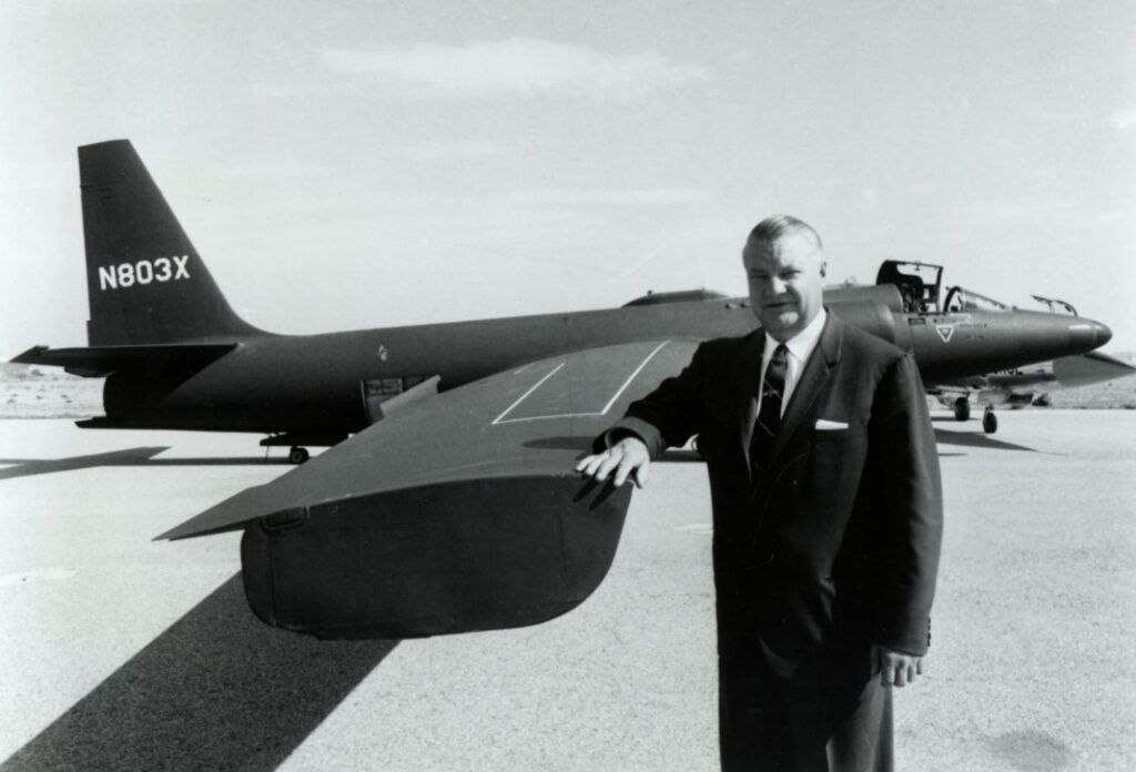 Clarence “Kelly” Johnson, Lockheed aircraft designer, standing beside an early U-2 spy plane developed for secret Cold War reconnaissance missions.