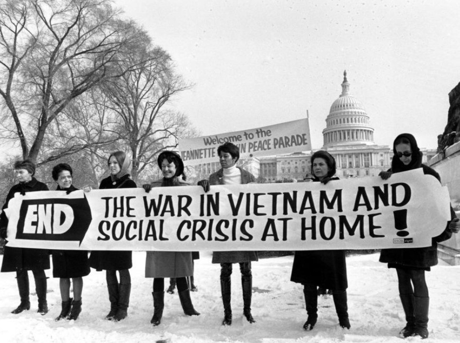 Jeannette Rankin with women antiwar demonstrators holding a banner protesting the Vietnam War during the Jeannette Rankin Brigade march in Washington, D.C., in January 1968.