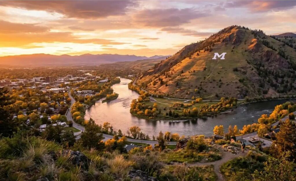 Sunset over the Clark Fork River in Missoula, Montana, with colorful skies reflected in the water.